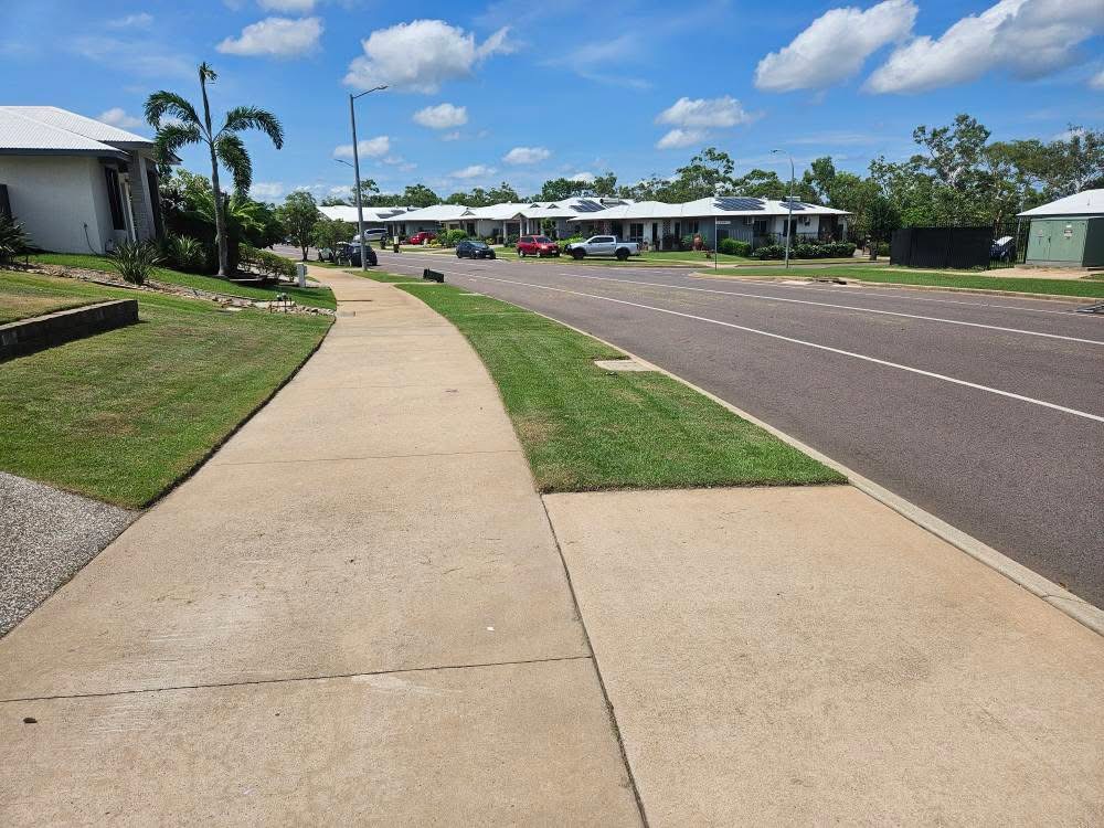 Trimmed and edged nature strip along a suburban footpath