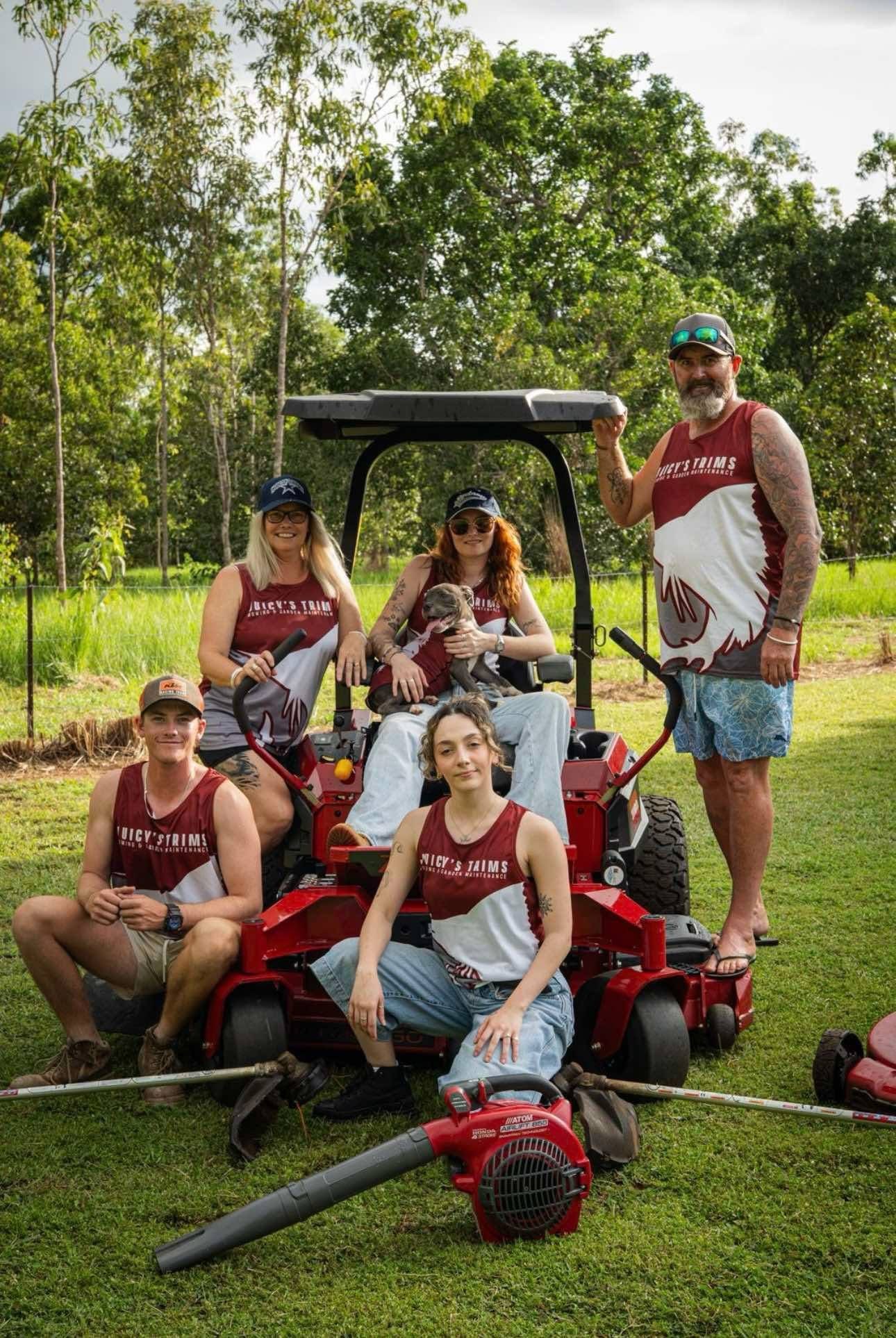 The Juicy's Trims team with their ride-on mower